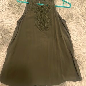Green sleeveless top.